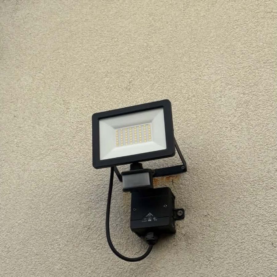 A replacement LED floodlight and sensor fitted neatly to an outside wall